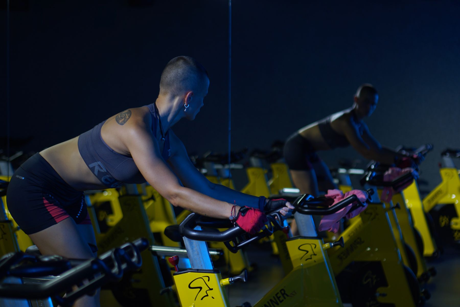 Cyclist training on an indoor trainer in a dimly lit room