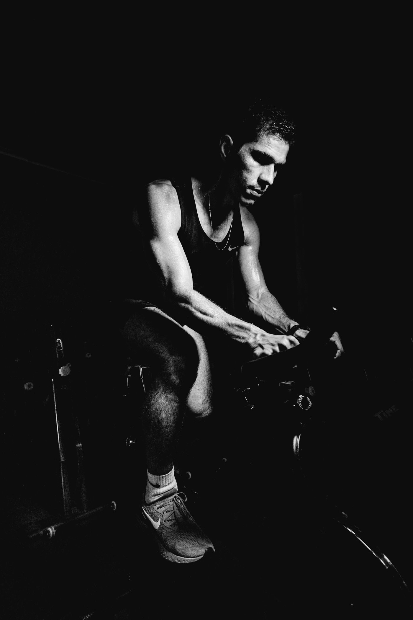 Cyclist under load on an indoor trainer, black and white