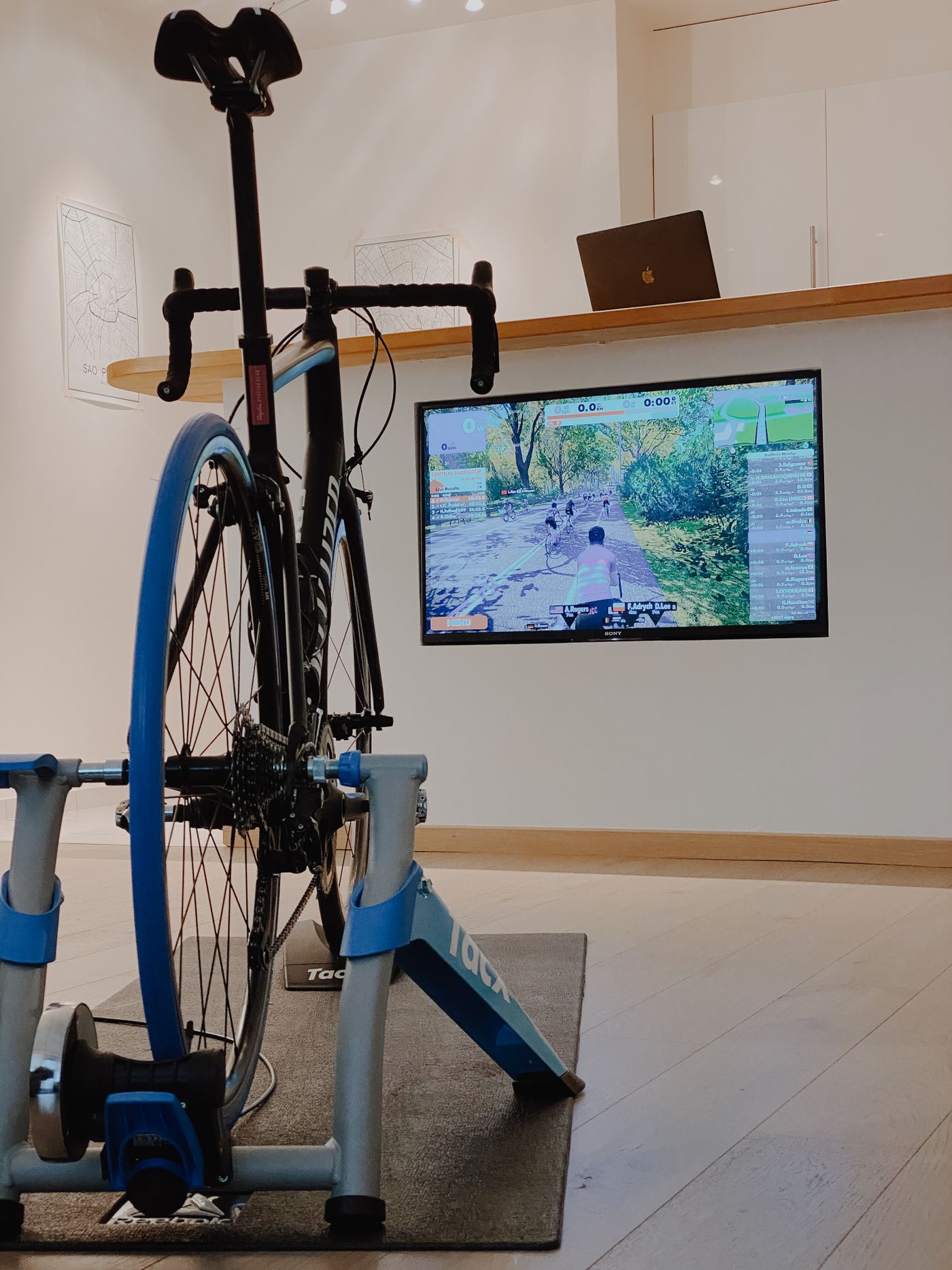 Road bike mounted on an indoor trainer in front of a screen